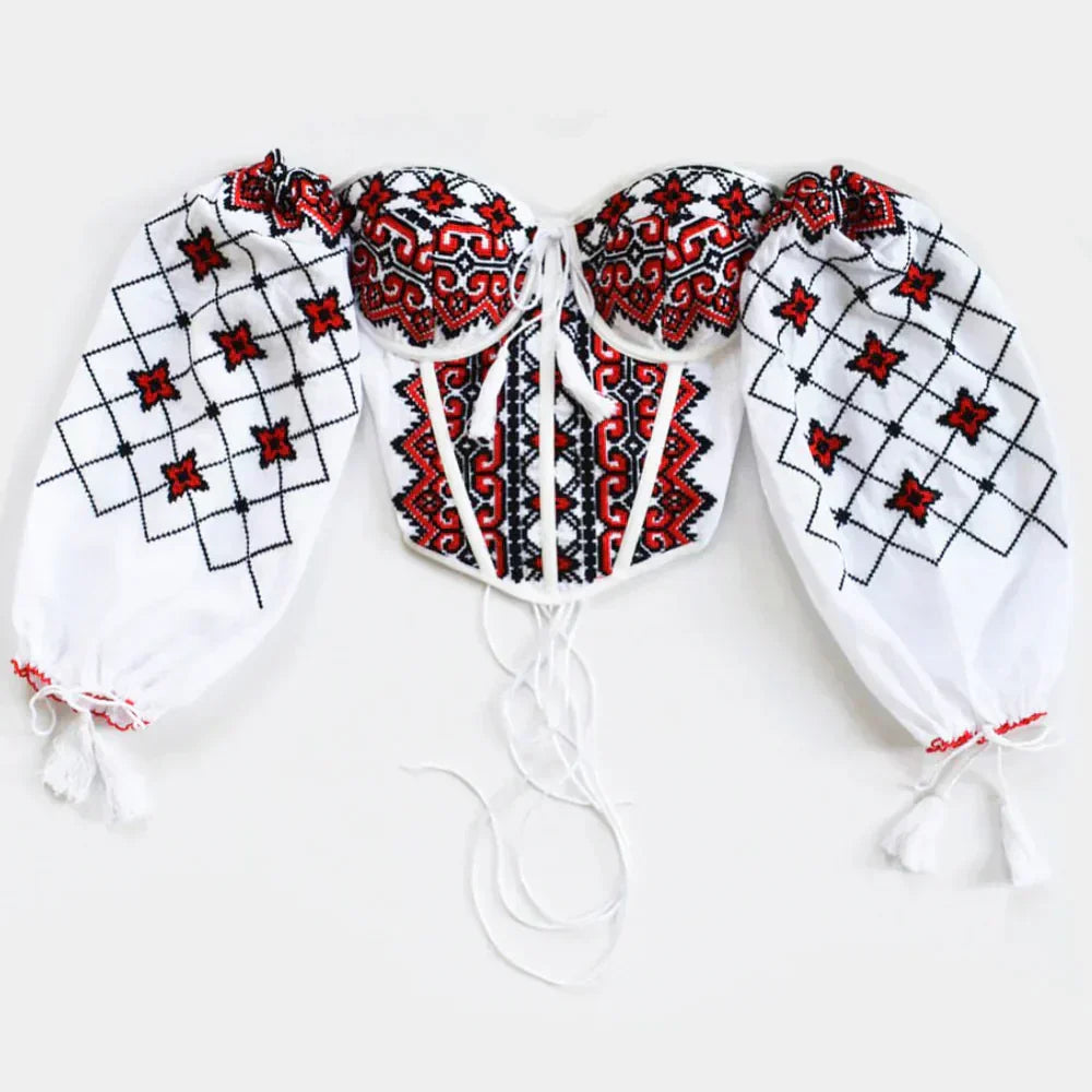 Traditional Romanian corset with embroidered red and black geometric patterns and voluminous sleeves.