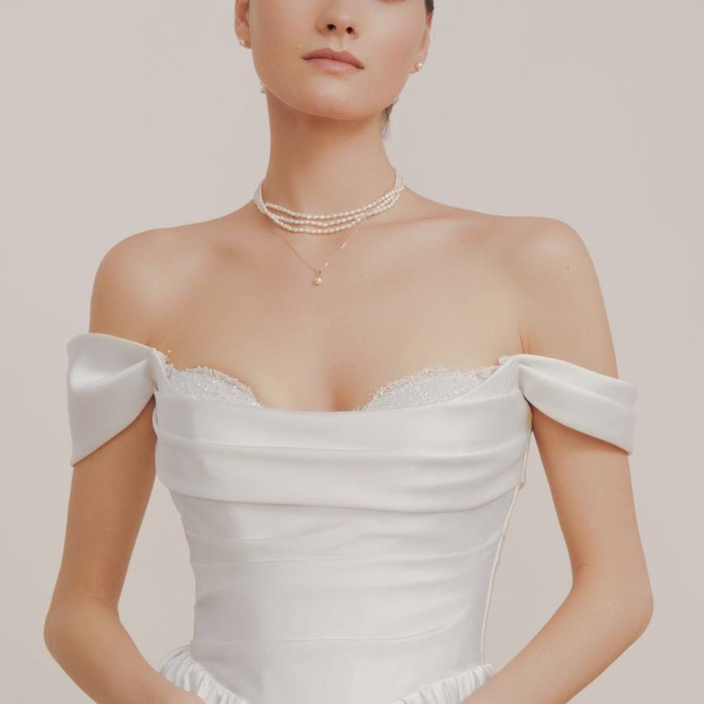 White pearl beaded necklace and chain pendant necklace with one pearl and pearl earrings for bride's outfit