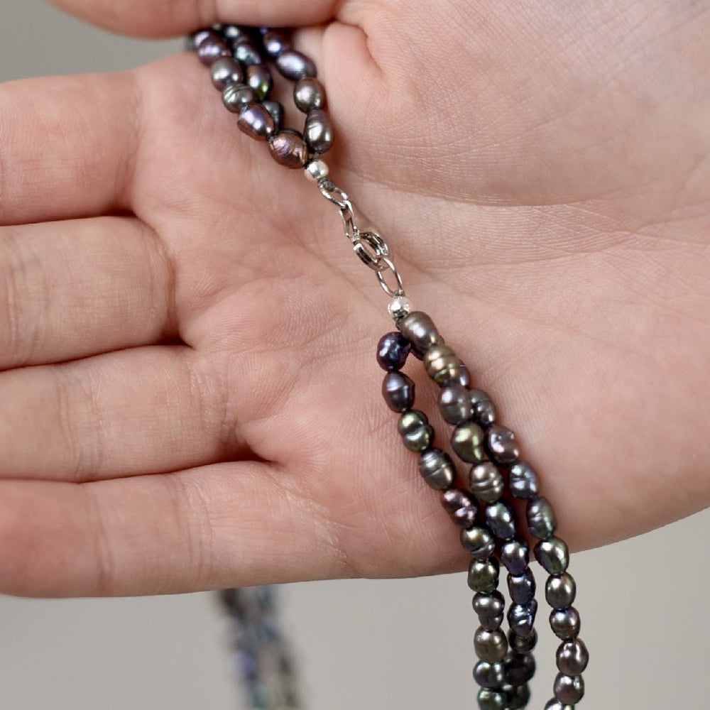 
                      
                        Choker with three rows of black baroque pearls
                      
                    