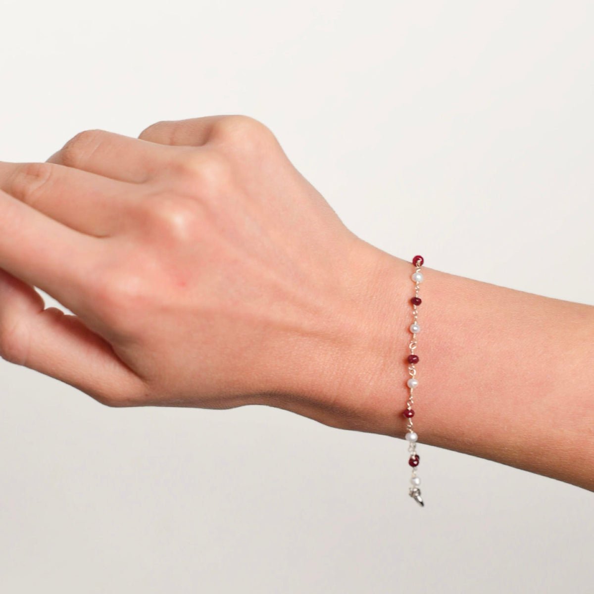 A delicate bracelet with 3 mm round pearls and a ruby