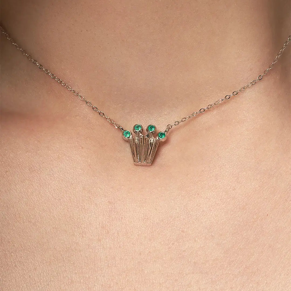 Silver chain necklace with a crown form pendant with green onyx gemstones