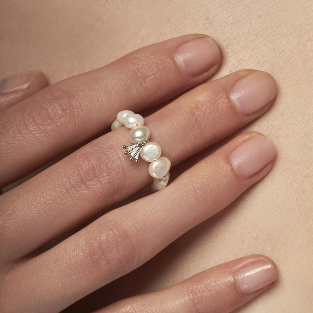 White baroque pearl ring with a silver Frog paw-shaped pendant