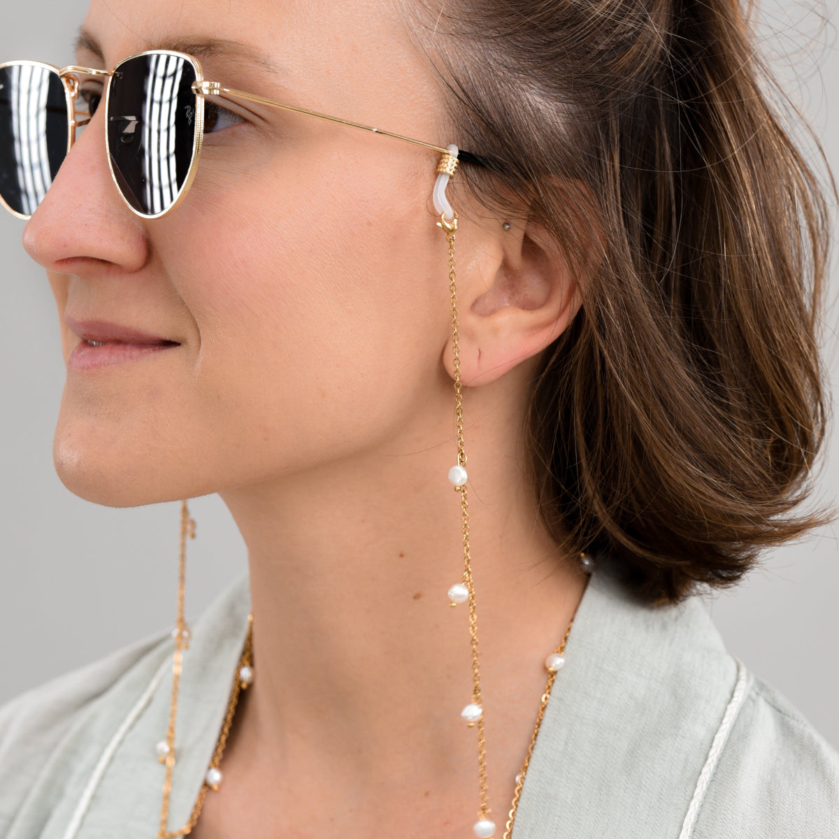 Sunglasses with a gold pearl chain