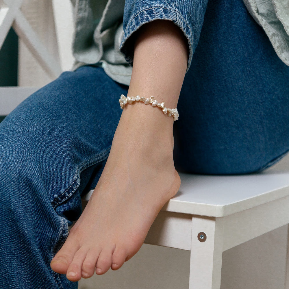 Keshi pearl anklet worn on an ankle, displayed with casual jeans.