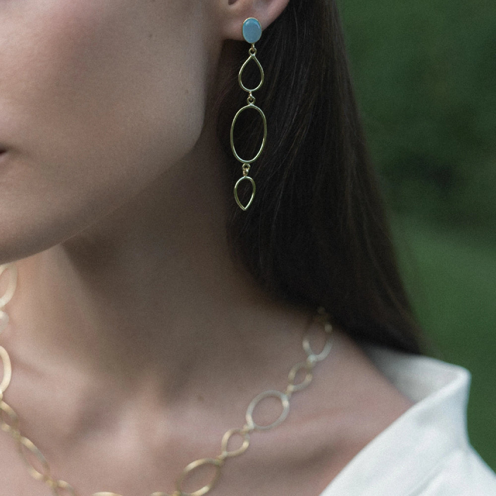 
                      
                        Gold-plated silver earrings with natural pear cabochon Aqua Chalcedony stone.
                      
                    