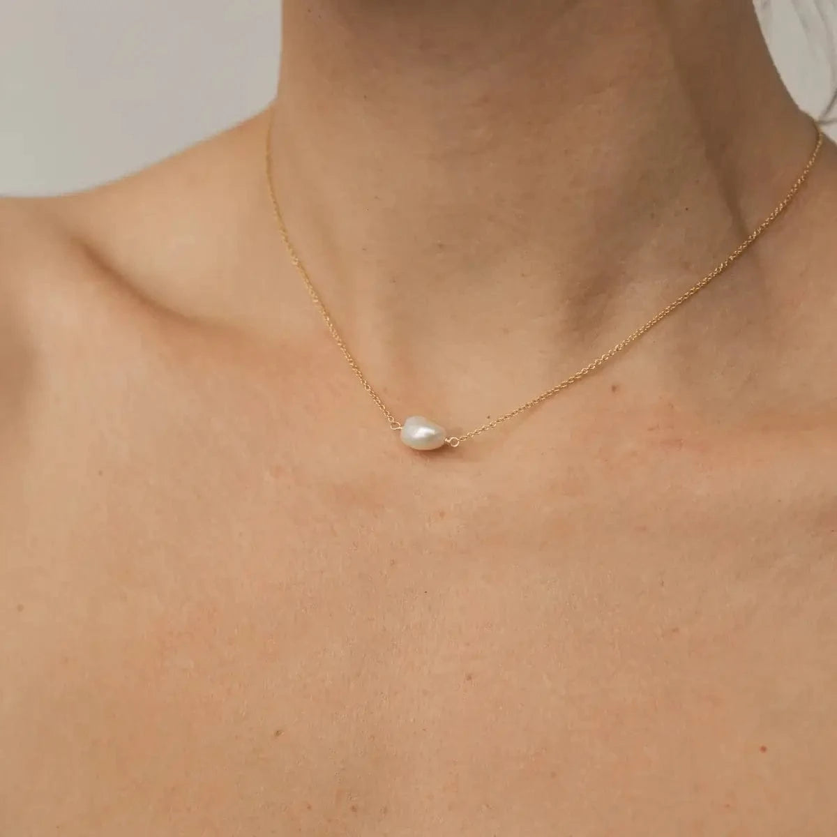 Gold-filled chain choker and baroque pearl photo